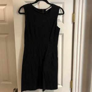 Black dress with gold zipper and side slit pockets